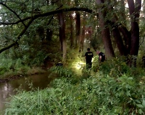 policjanci stojący przy zbiorniku wodnym